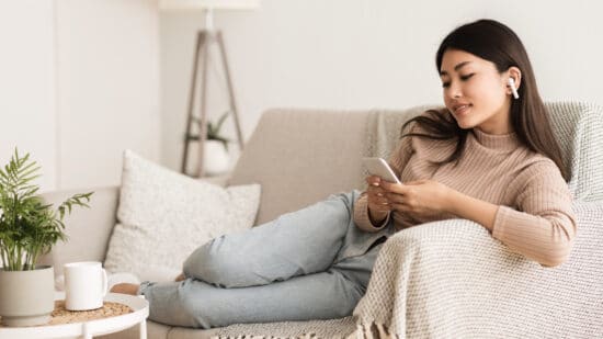 Smiling Lady on Couch with Phone