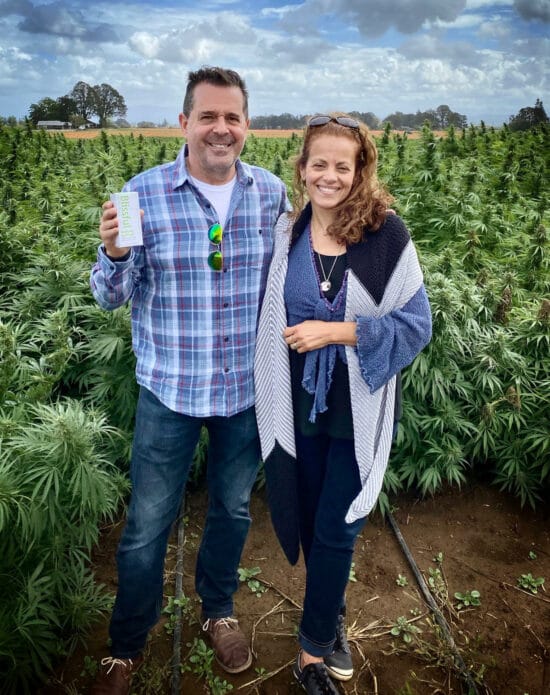 Founders Holding Blissful Plant Box in Hemp Field